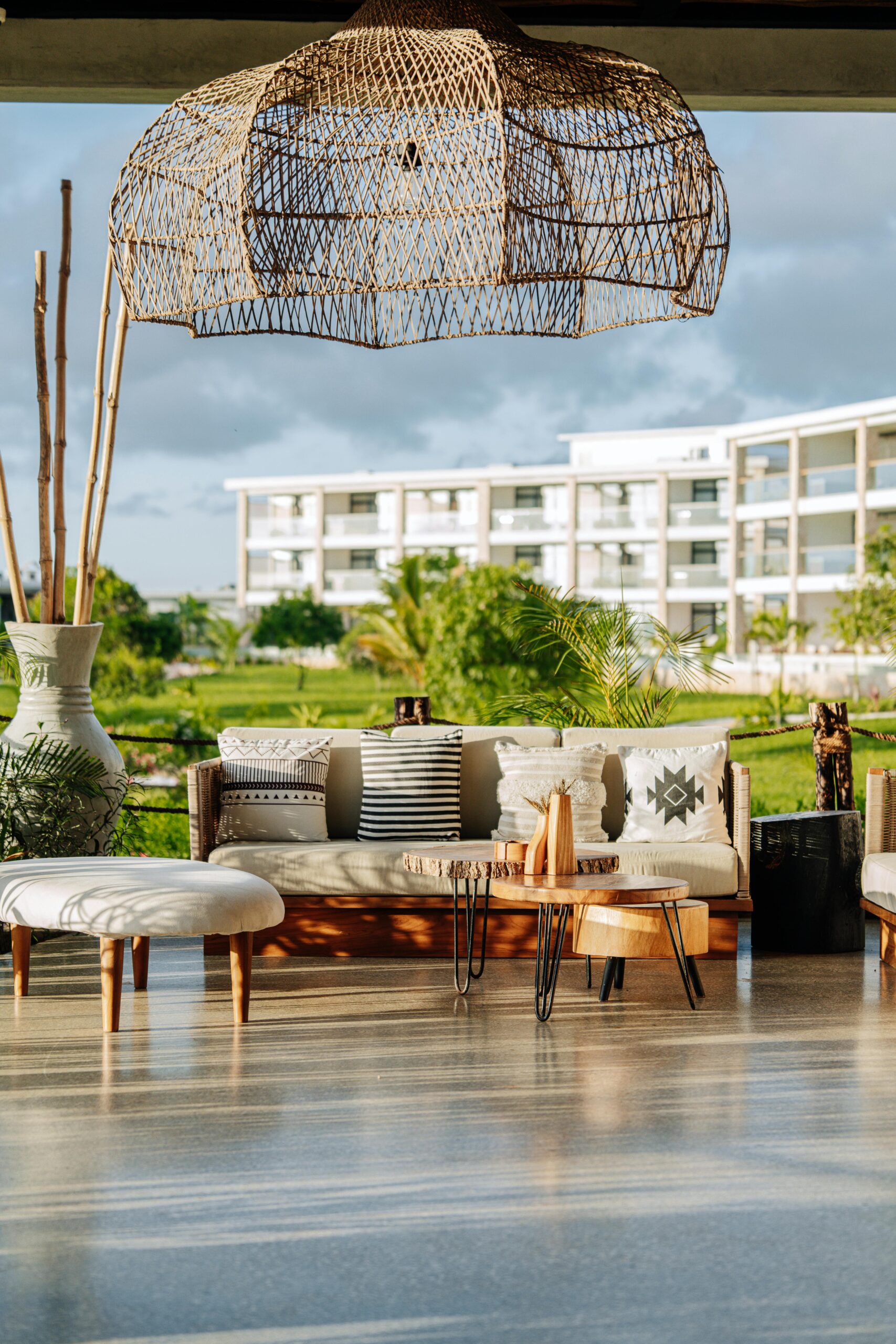 Elegant outdoor terrace in Zanzibar showcasing modern furniture and lush greenery, perfect for relaxation.